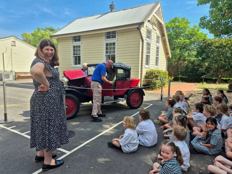 Mrs Reedman and students looking and learning about 'Bubsie' the restored 1923 Citroen red car