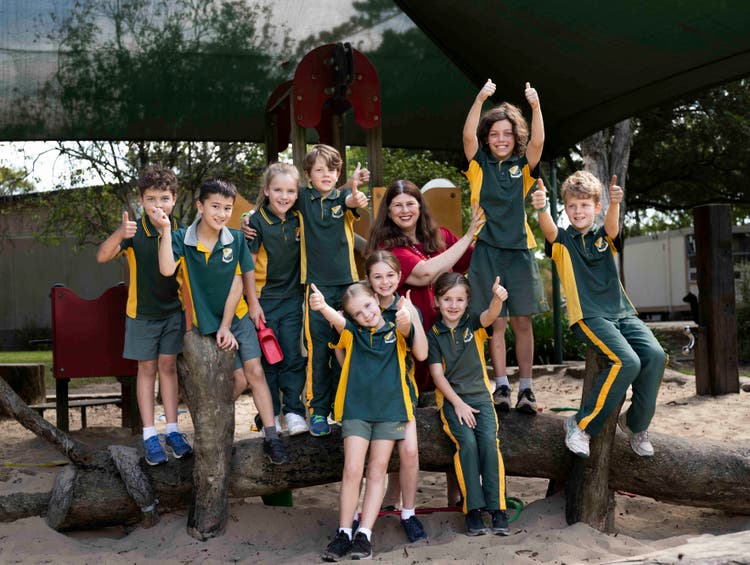 A hero banner displaying students and our Principal at one of two sand pits at our school