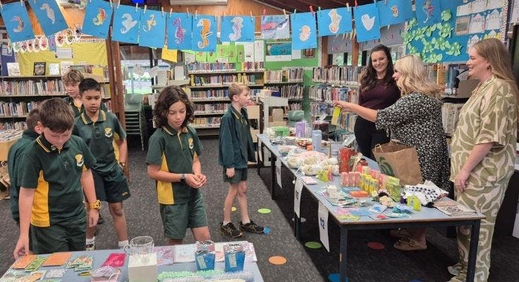 Mums volunteering at the mothers day stall with students purchasing gifts